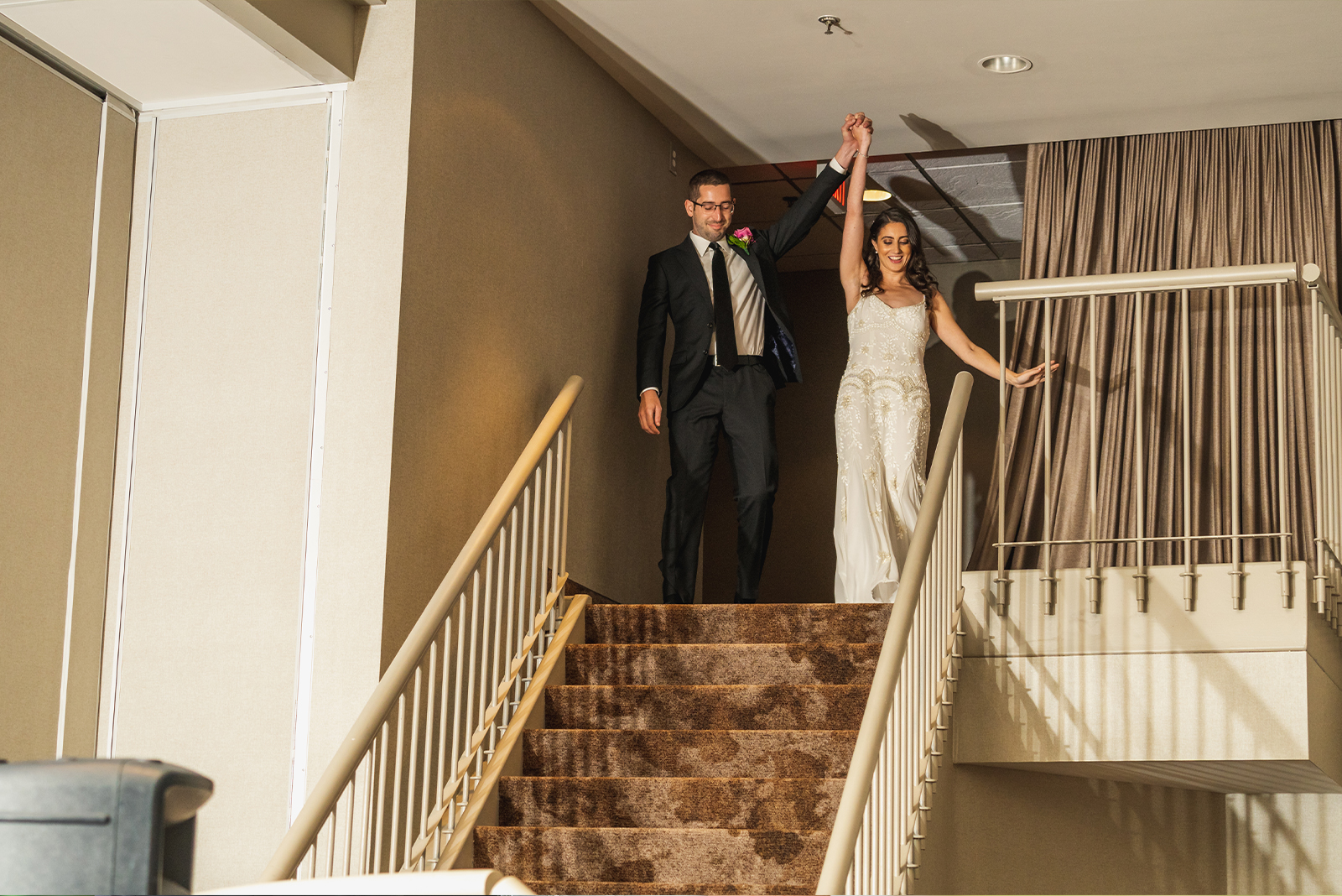 Bride and groom cheering, bridal party entrance, staircase, happy, candid wedding photo, classy wedding reception at Landerhaven, Mayfield Heights OH