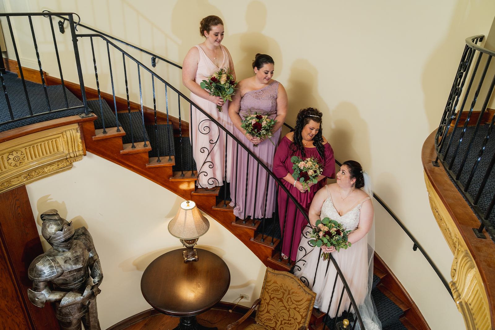 Bride and bridesmaids on staircase, bridal party portrait, cute bridal party portrait, formal, outdoor September wedding ceremony at Punderson Manor Lodge & Conference Center