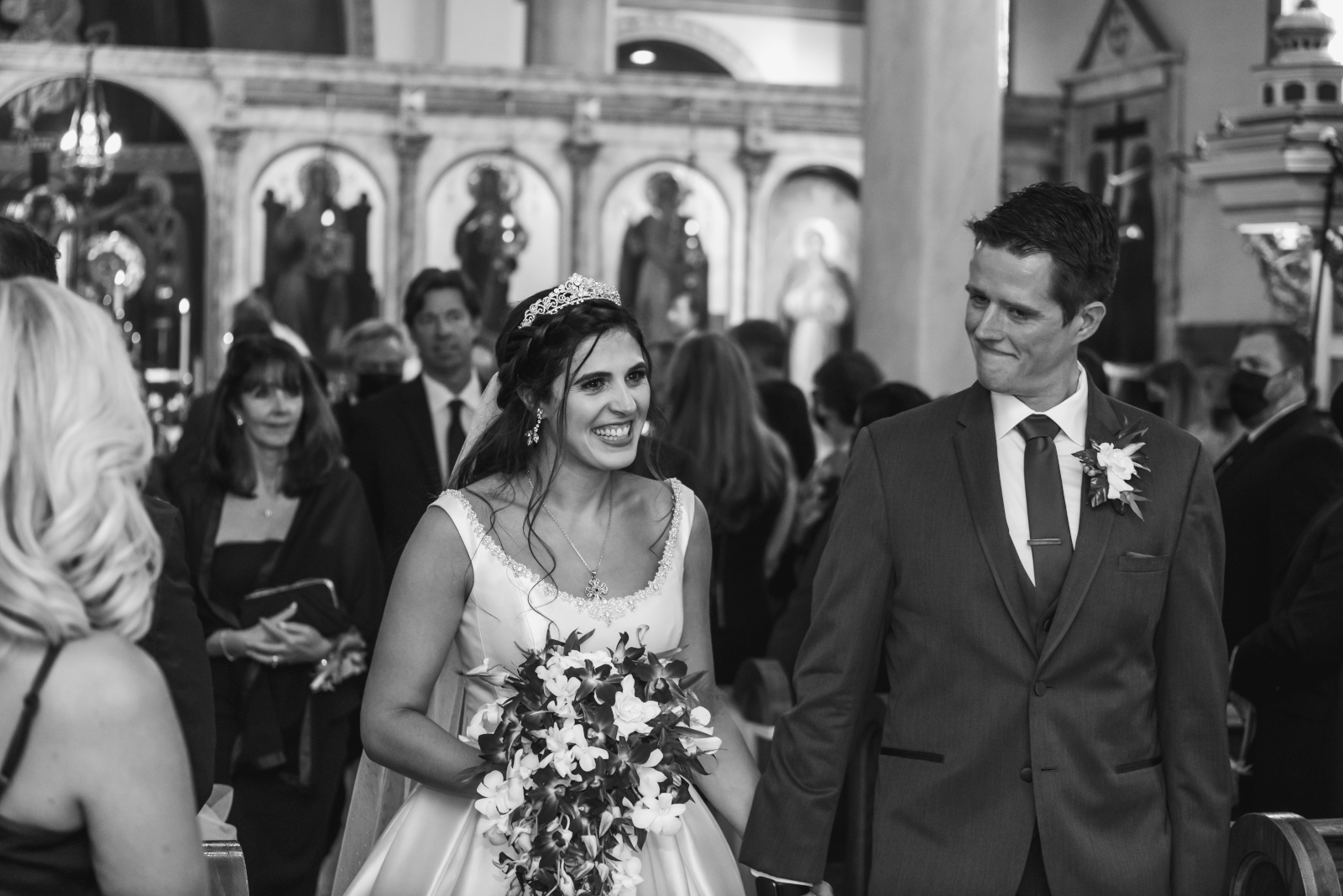 Bride and groom smiling, bridal party processional, classic wedding photo, black and white, Greek Orthodox wedding, church, sweet wedding ceremony at Crocker Park, Westlake OH