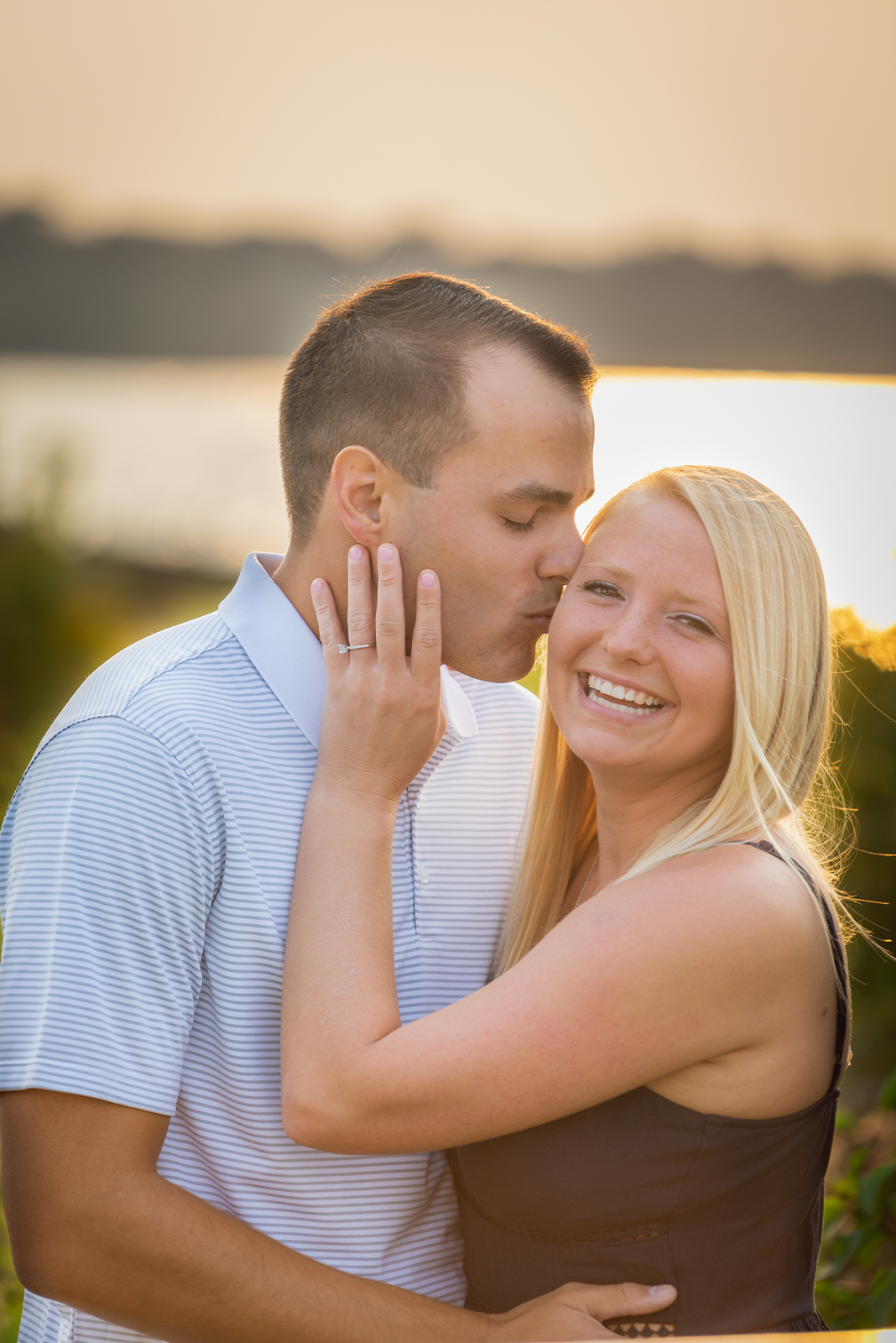 Man and woman fiancee engagement photo, couple portrait, kiss, smile, engagement ring, cute, sweet, sunset, golden hour, nature, Lake Erie, Edgewater Beach, Cleveland Metroparks
