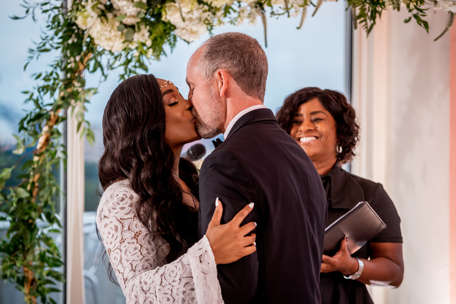 Bride and groom kiss, wedding ceremony, African American bride, African American wedding, urban wedding ceremony at Penthouse Events, Ohio City, Cleveland Flats
