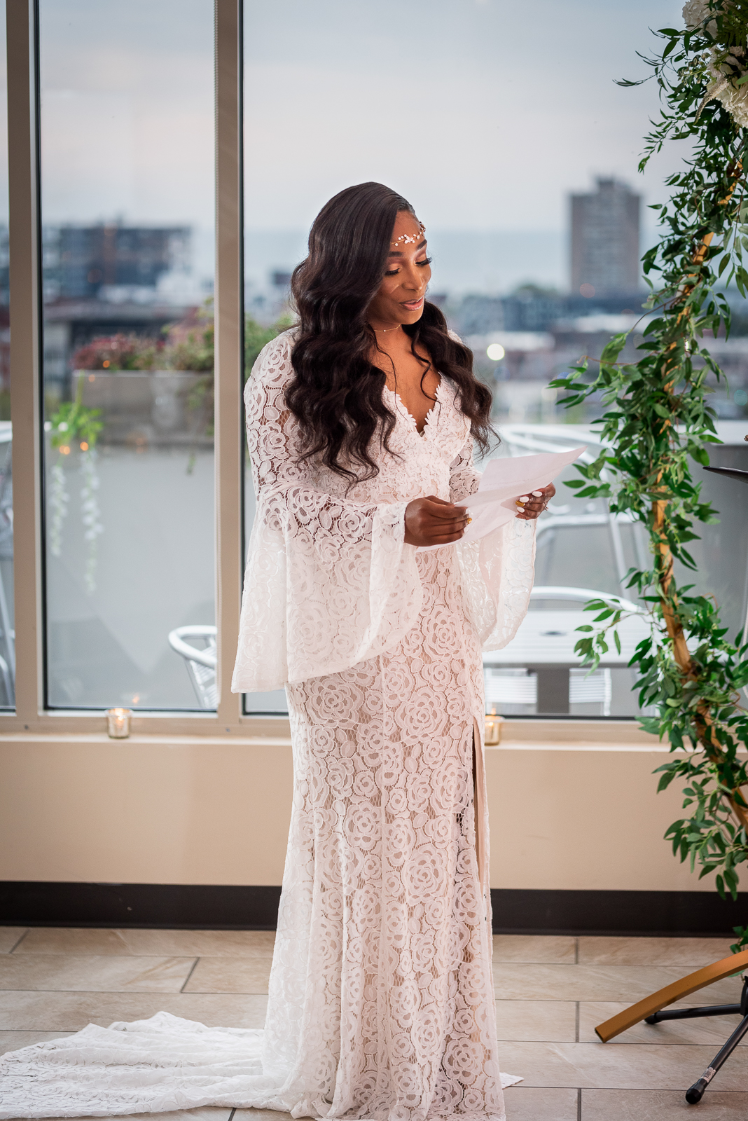 Bride reading vows, wedding ceremony, African American bride, African American wedding, downtown Cleveland skyline, Lake Erie, urban wedding ceremony at Penthouse Events, Ohio City, Cleveland Flats