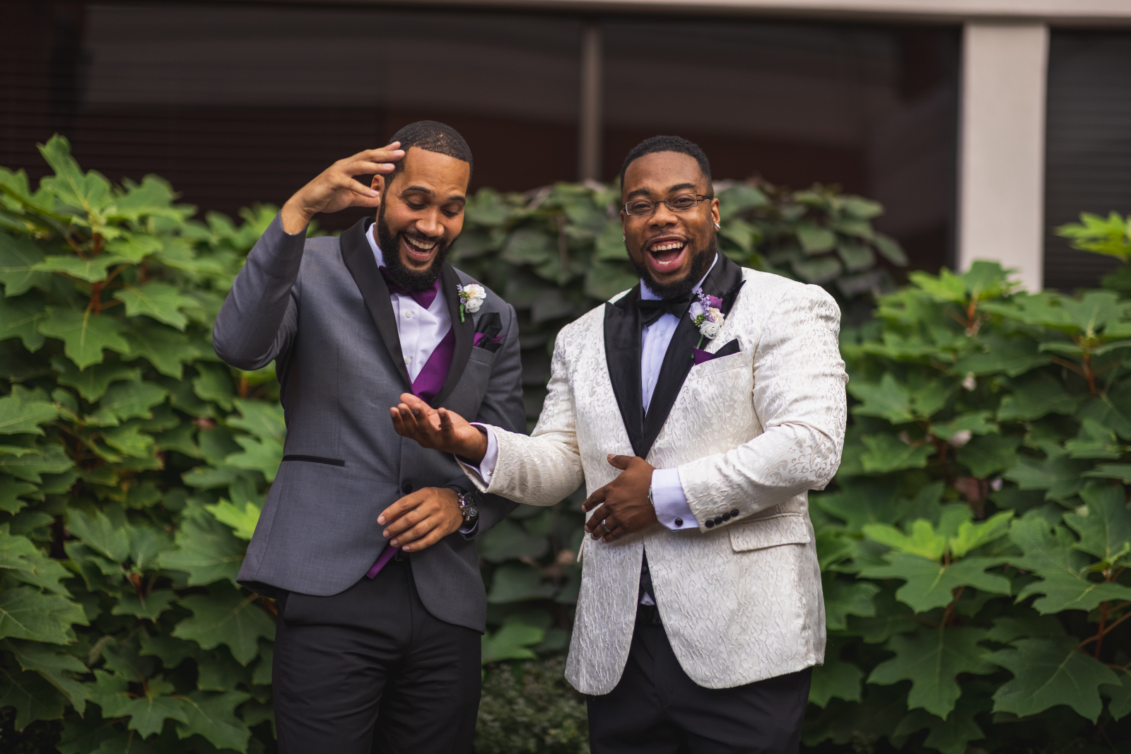 Groom with groomsman, fun bridal party portrait, green bushes, nature, African American groom, African American wedding, romantic wedding ceremony at Hilton Akron/Fairlawn