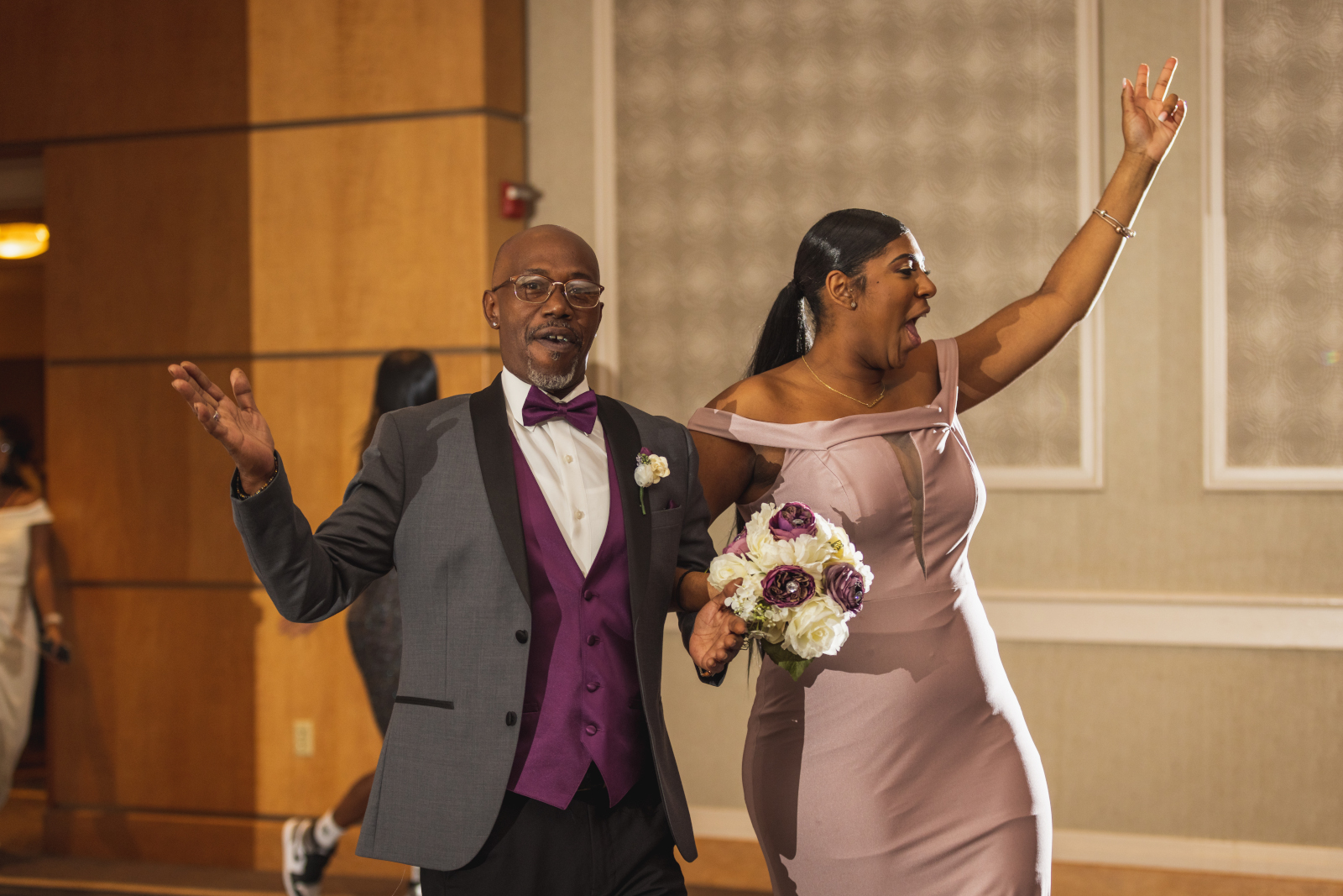 Father of the groom with bridesmaid, fun bridal party entrance, African American wedding, romantic wedding reception at Hilton Akron/Fairlawn