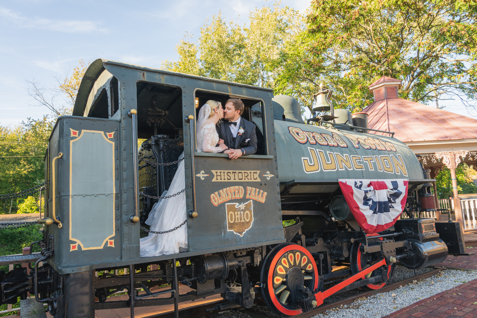 Bride and groom wedding portrait, train, unique wedding photo, cute, kiss, Historic Olmsted Falls Ohio, Grand Pacific Junction, fall wedding, cute outdoor wedding ceremony at Grand Pacific Wedding Gardens