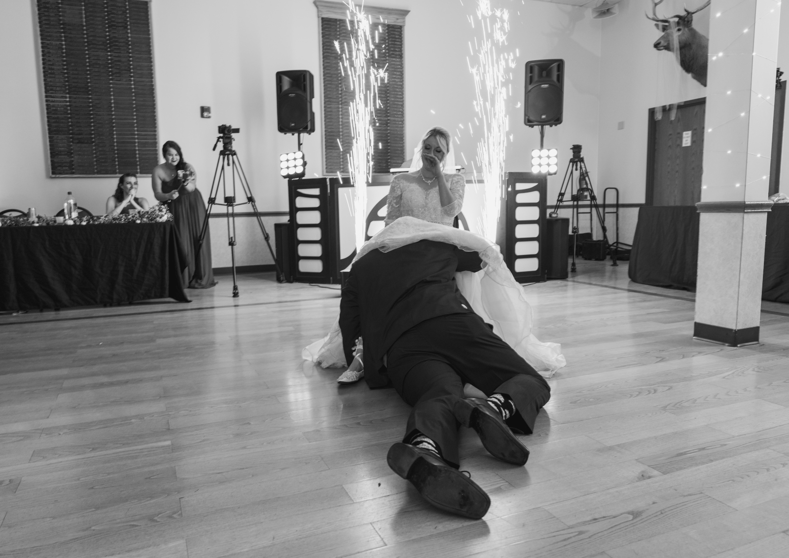 Bride and groom, garter removal, funny wedding photo, black and white, sparks, indoor fireworks, Sparkular cool sparkler machine, fall wedding, cute fall wedding reception at Grand Pacific Wedding Gardens