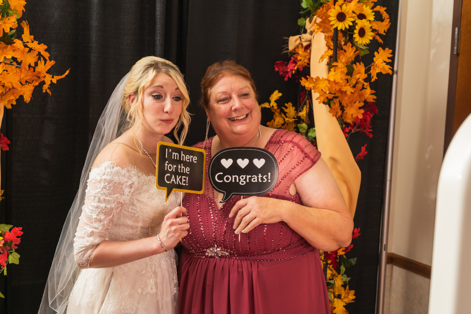 Bride and mom, mother of the bride, photo booth, props, signs, smile, pose, candid, fall wedding, cute fall wedding reception at Grand Pacific Wedding Gardens