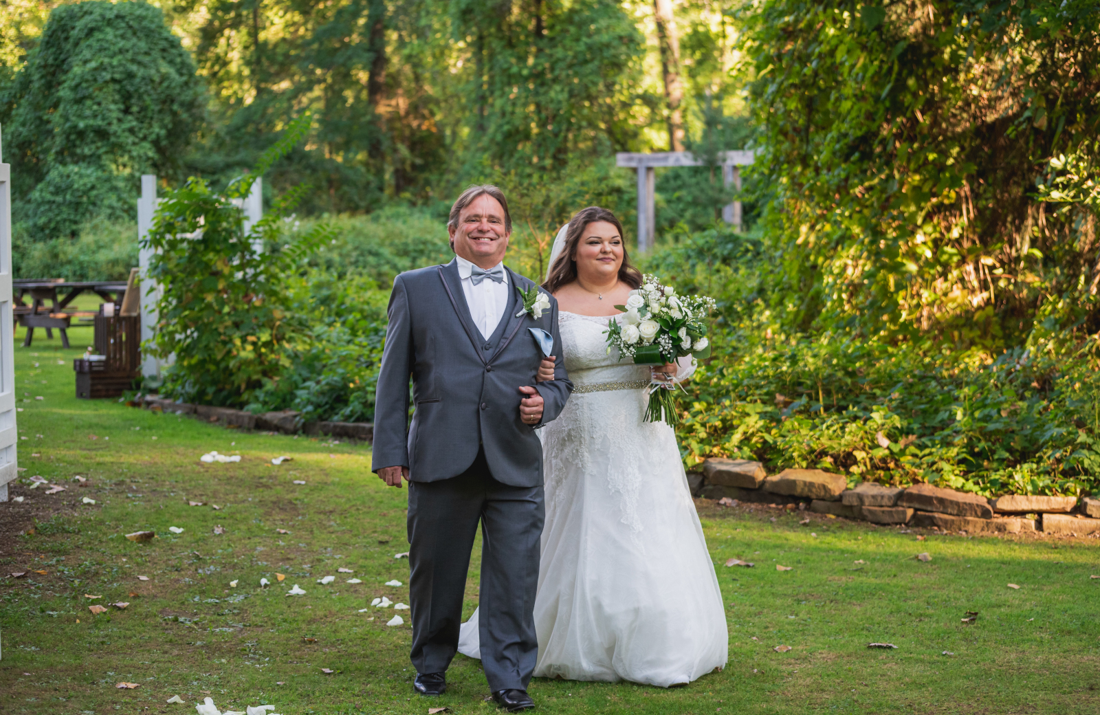 Bride with dad, father of the bride, bridal march, bridal processional, green, nature, outdoor September wedding ceremony at Westfall Event Center