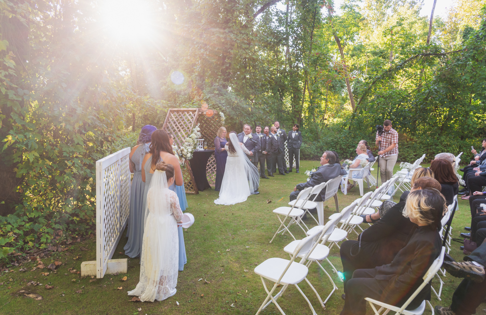 Bride and groom, wedding ceremony, sunlight, lens flare, outdoor September wedding ceremony at Westfall Event Center