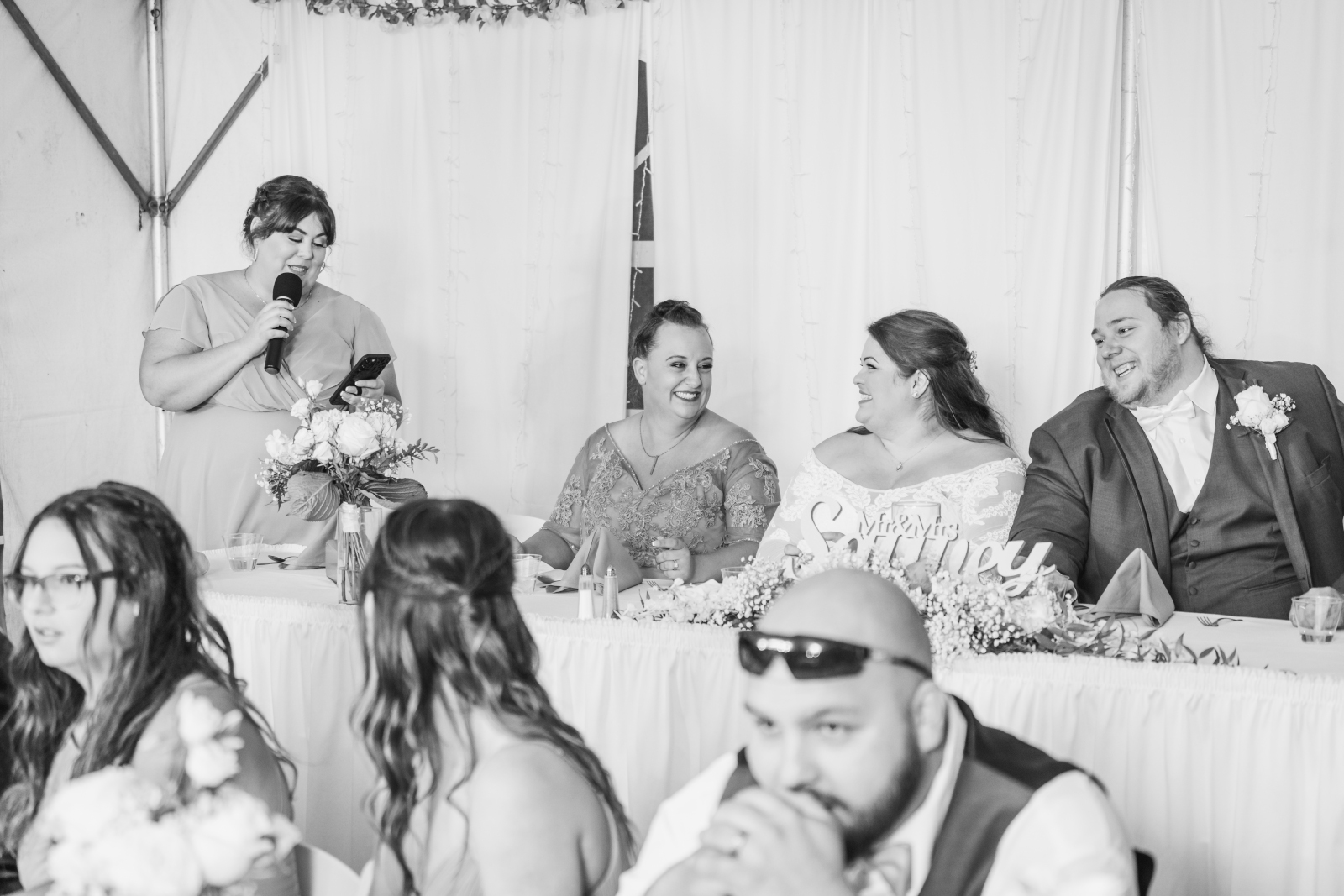Bridesmaid speech, wedding speech, wedding toast, bride and groom laughing, black and white, September wedding reception at Westfall Event Center