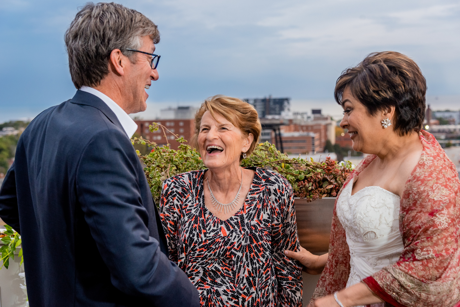 Bride and groom with groom's mom, mother of the groom, smiling, laughing, candid wedding photo, gorgeous wedding photo, cute, sweet, older couple, romantic urban wedding ceremony at Penthouse Events, Ohio City, Cleveland flats, downtown Cleveland skyline, Lake Erie