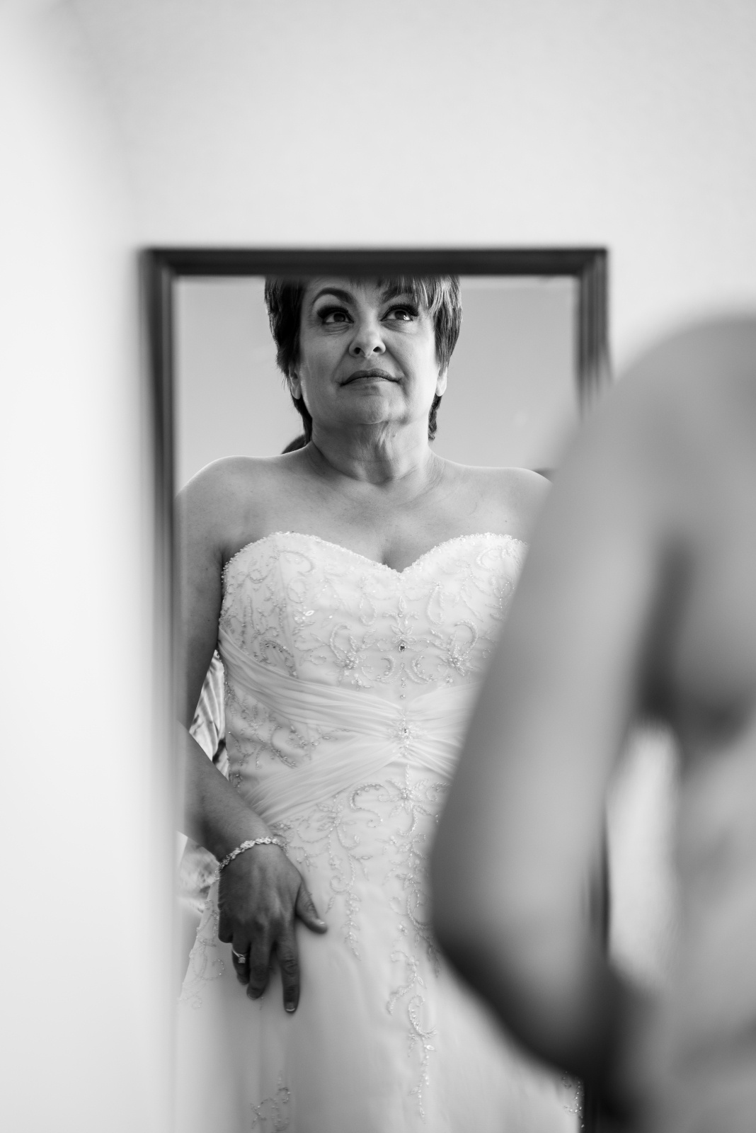 Bride looking in mirror, getting ready, wedding preparation, wedding dress, classic wedding photo, black and white, older bride, older couple, romantic outdoor urban wedding ceremony at Penthouse Events, Ohio City, Cleveland Flats