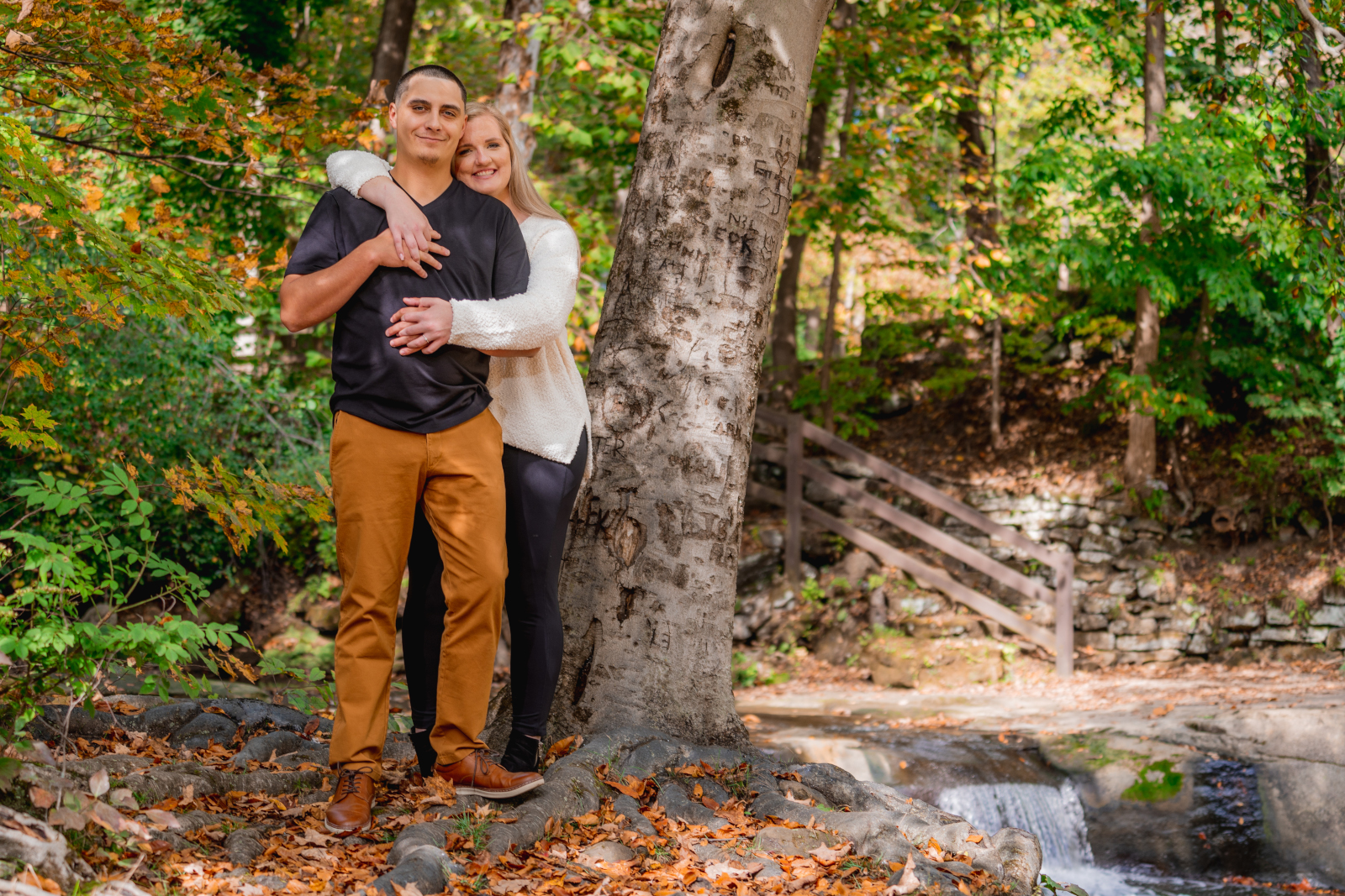 Man and woman fiancee engagement photo, couple portrait, cute, trees, fall leaves, fall colors, trees, nature, outdoor fall engagement photo session at Grand Pacific Junction Historic Shopping District
