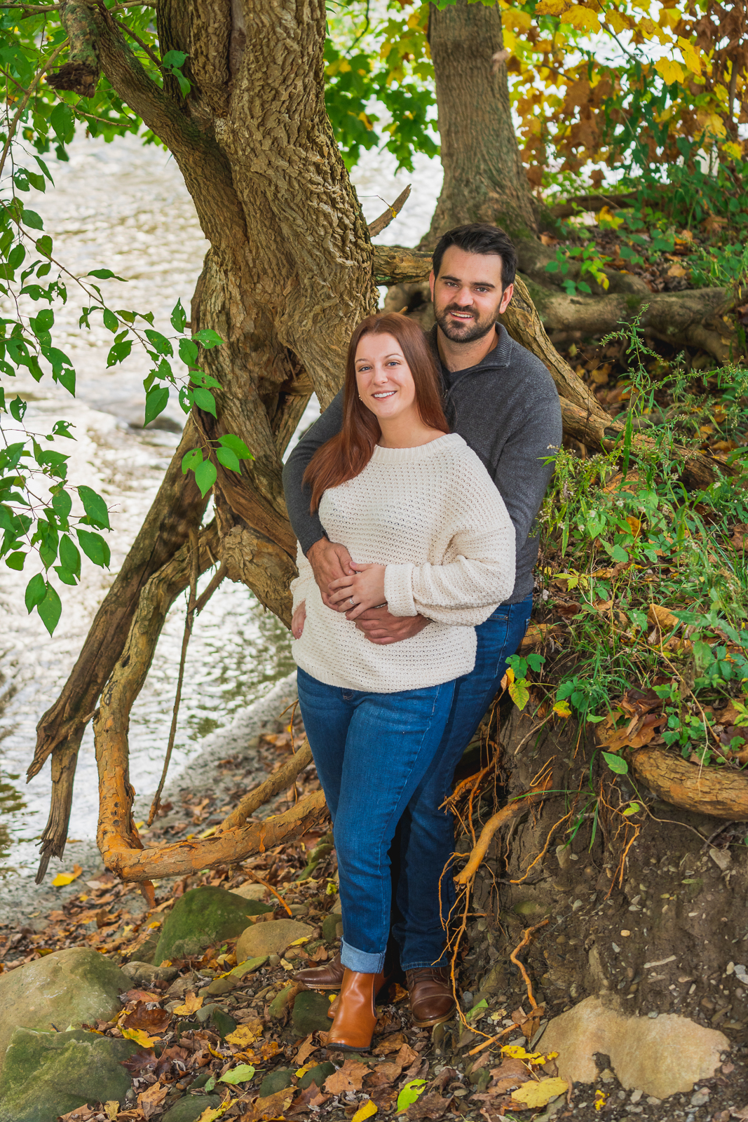 Man and woman fiancee engagement photo, couple portrait, creek, nature, fall leaves, fall colors, cute, smile, outdoor fall engagement photo session at Tinkers Creek, Bedford Reservation, Cleveland Metroparks