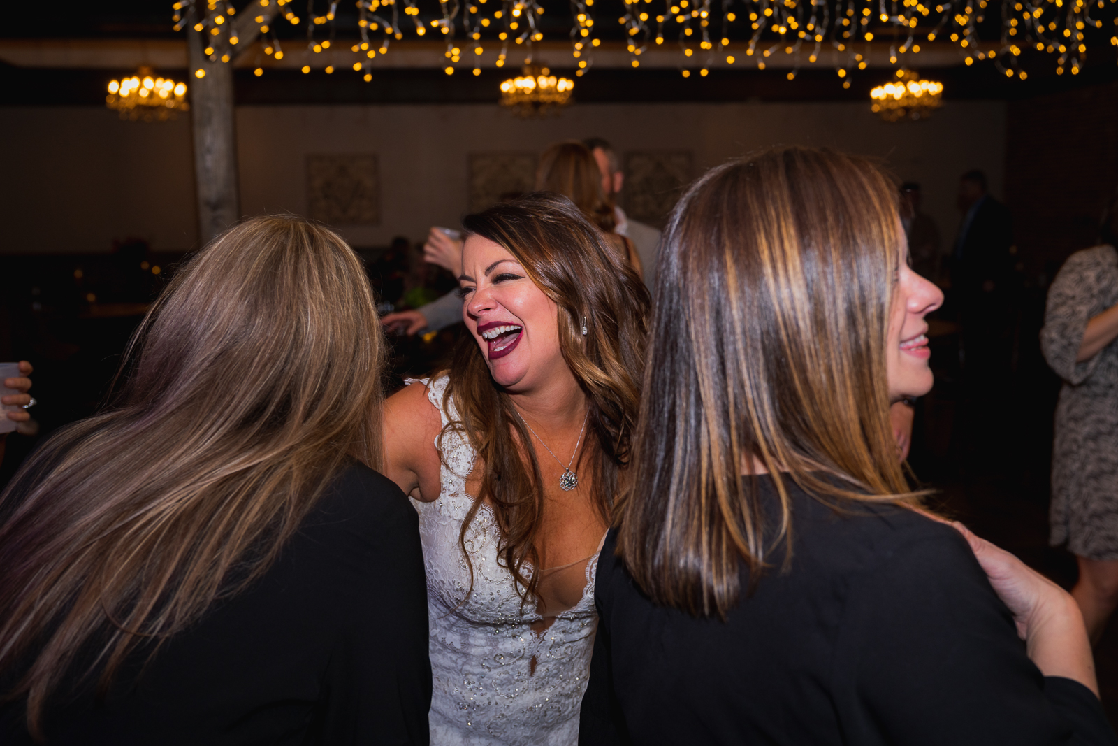 Bride smiling, laughing, dancing, wedding candid, wedding reception at Gather at the Lakes