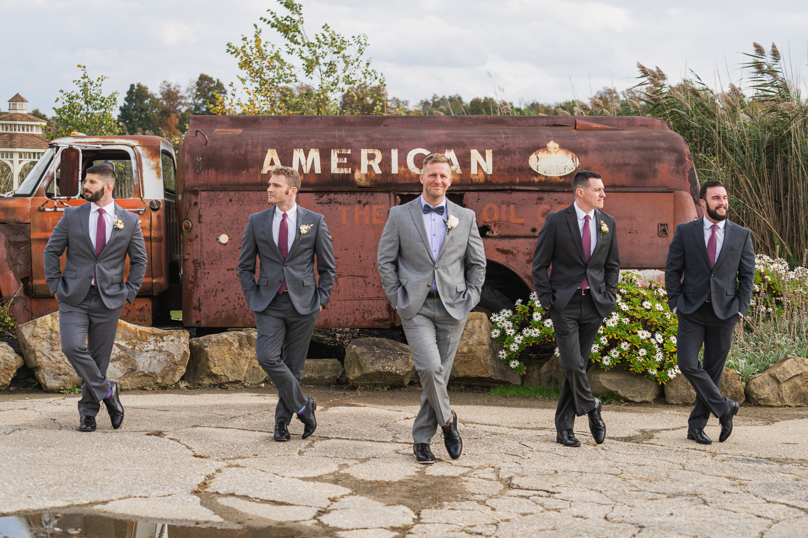 Groom with groomsmen, bridal party portrait, old truck, American oil, fall wedding, rustic outdoor wedding ceremony at White Birch Barn