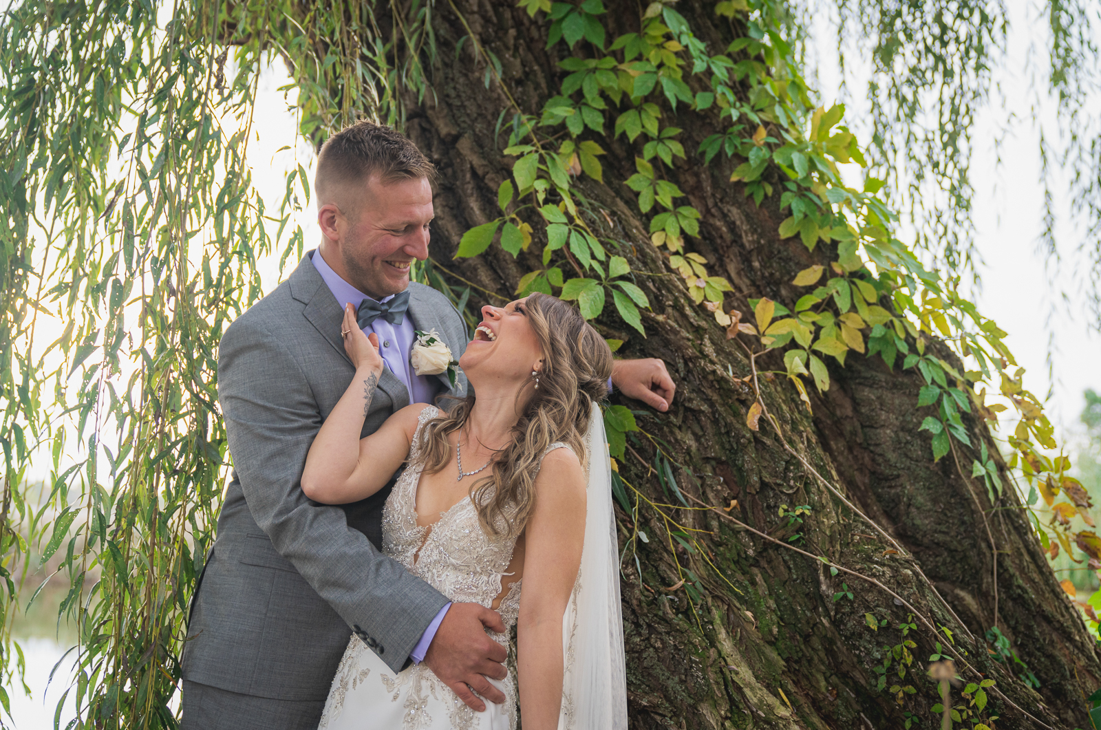 Bride and groom wedding portrait, smiling, laughing, weeping willow, tree, nature, fall wedding, rustic outdoor wedding ceremony at White Birch Barn