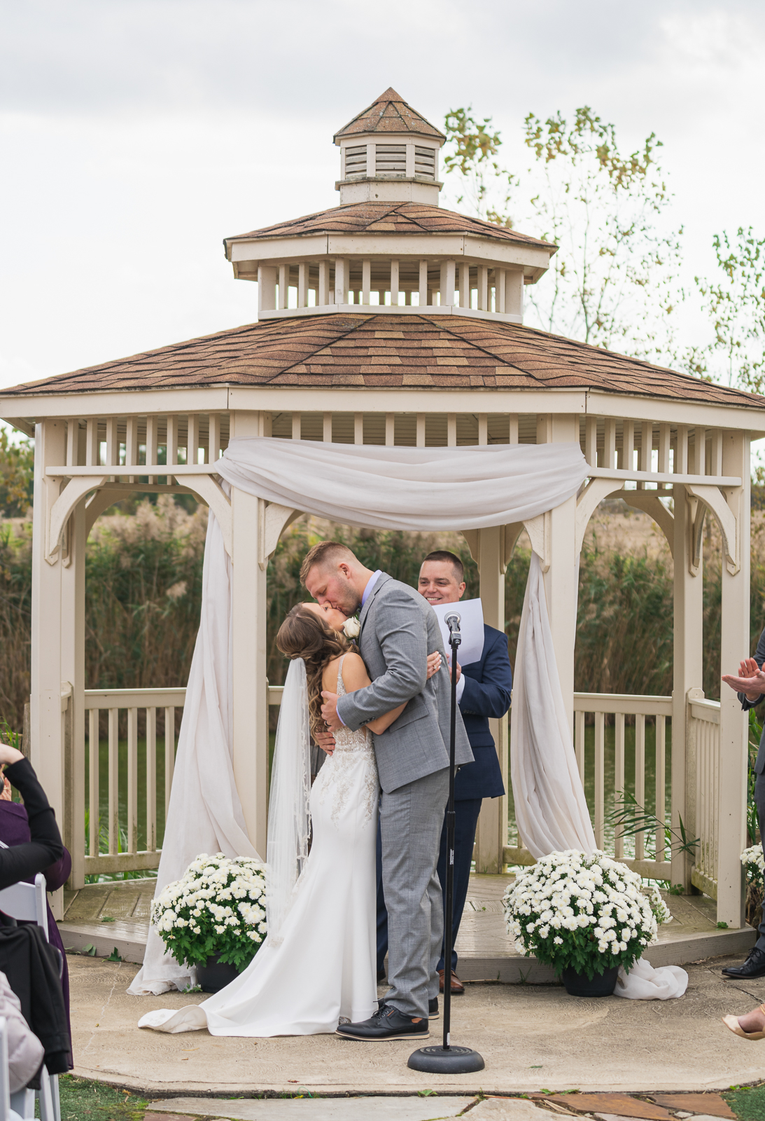 Bride and groom, kiss, gazebo, fall wedding, rustic outdoor wedding ceremony at White Birch Barn